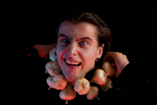 Funny vampire suffocated from being choked by garlic